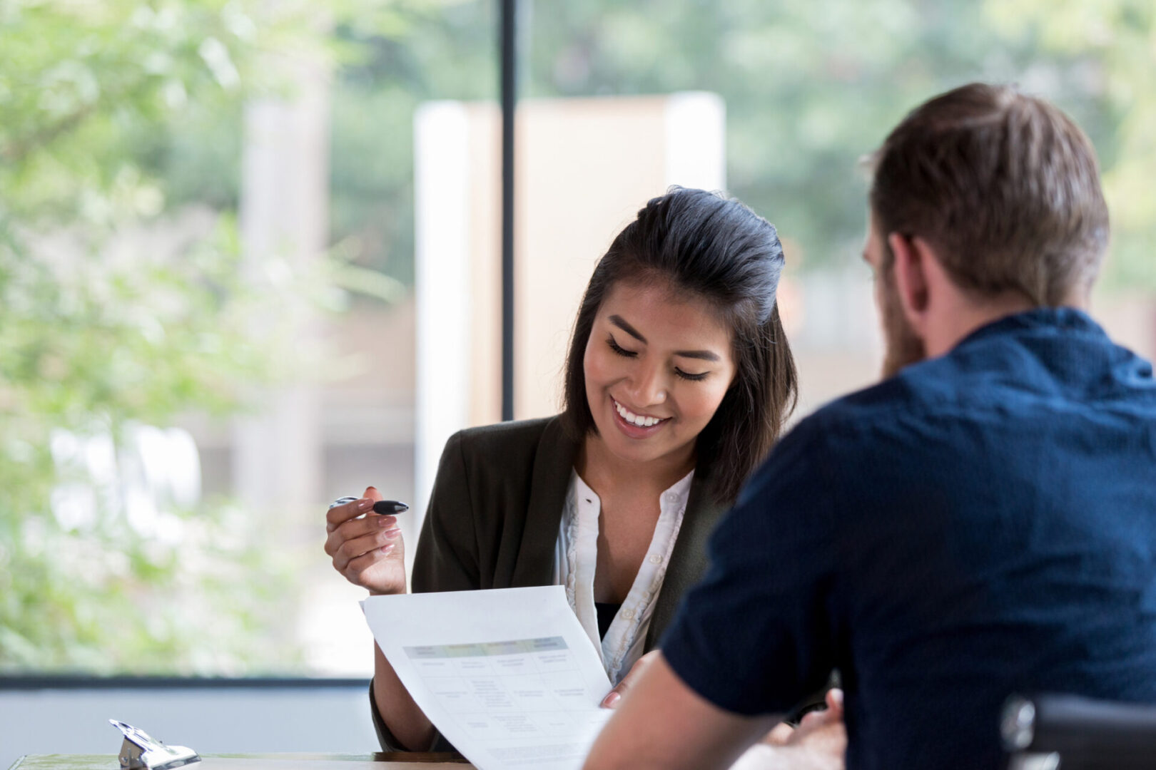 Man and woman reviewing document together.