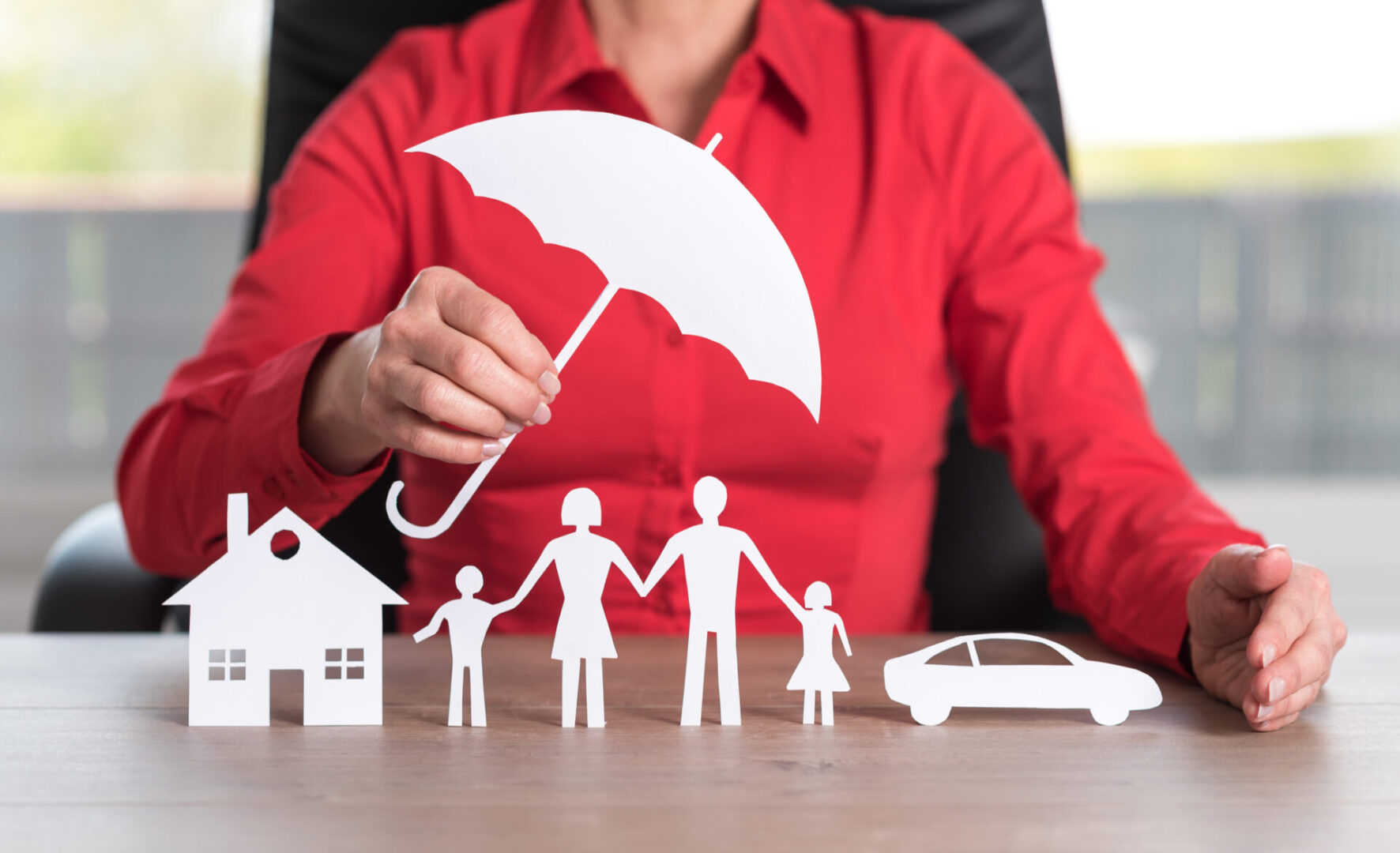 Paper cutouts of family, house, umbrella, car.